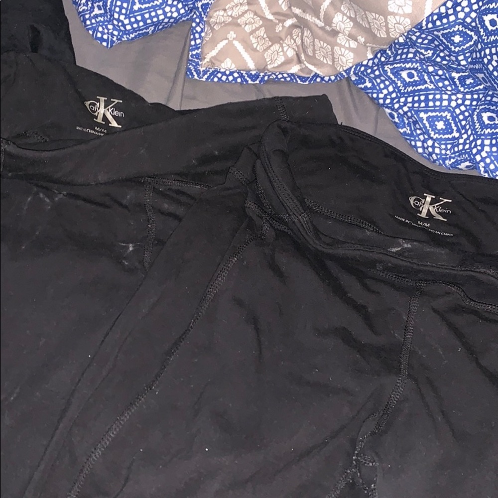 TWO pairs of Calvin Klein capri leggings